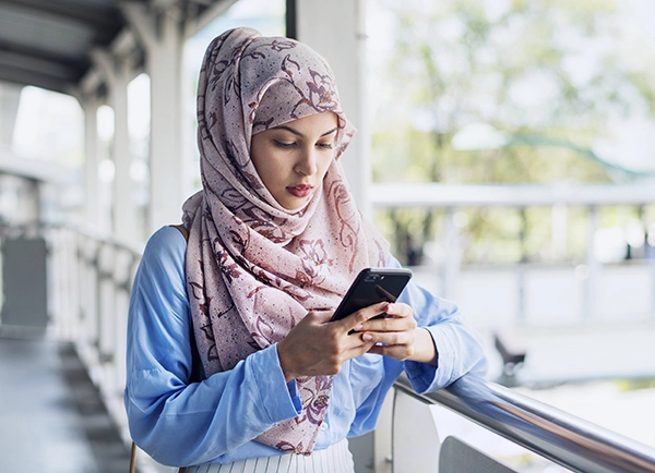 islamic woman texting messaging on the phone 2022 09 16 07 38 04 utc